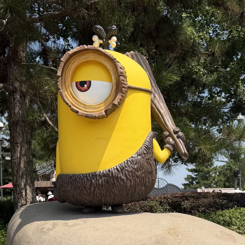 Minions figure in a wooded theme park setting